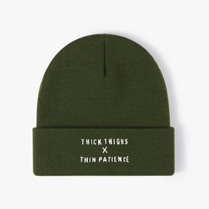 Deep green knit beanie featuring white THICK THIGHS X THIN PATIENCE text embroidery