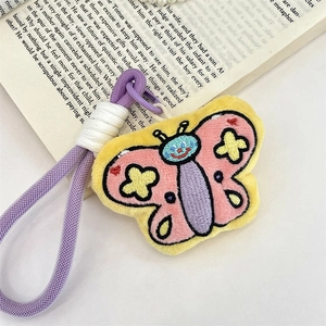 Detail of pink and yellow plush butterfly keychain with star and heart embroidery