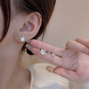 Elegant S925 silver stud earrings set with cat eye stone and pearls shown on model