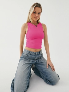 Close-up of hot pink sleeveless crop top with smooth elastic knit texture for women