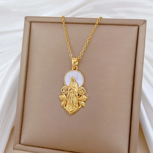 Close-up of gold-plated necklace with Mary portrait on white shell and floral motifs