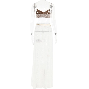 Detailed white lace two-piece set with a backless crop top, long skirt, and gold waist chain