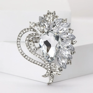 Macro shot of silver crystal brooch with pear-cut zircon and floral rhinestone pattern