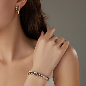 Close-up of model wearing two-tone gold and silver link bracelet with pave rhinestones