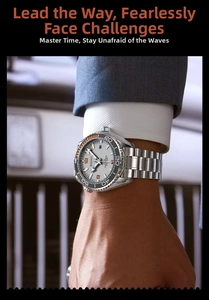 Detail of silver stainless steel diver watch with grey dial worn with a navy suit