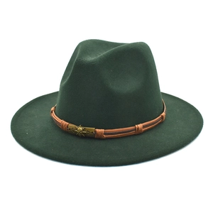 Detail of dark green fedora with brown woven band and bronze skull buckle accessory