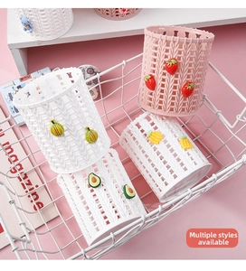 Detail of round desktop organizers with plastic woven texture and cute fruit icons