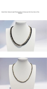 Detail shot of black and beige beaded necklace displayed on a mannequin stand
