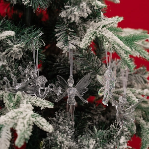 Set of 4 transparent acrylic angel and ballet girl ornaments on snowy Christmas tree