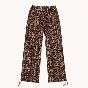 Loose leopard print cargo pants with drawstring hem and multiple pockets on white background