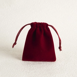 Detailed view of luxury burgundy velvet drawstring pouch for jewelry and gift packaging