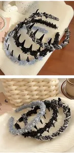 Detail of tweed headband with pearls and edgy spikes on a cozy textured background