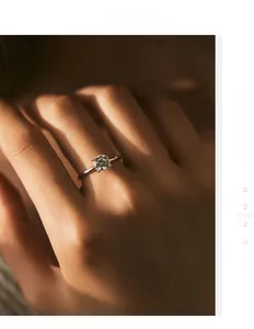 Close-up of a brilliant 1-carat moissanite ring with a classic four-prong silver setting