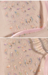 Macro detail of 3D rainbow butterfly nail stickers with rhinestones and moon motifs