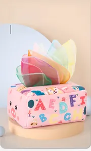 Macro shot of colorful chiffon scarves pulling out from a pink plush sensory tissue box toy