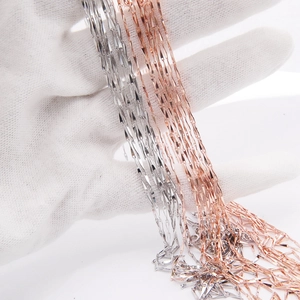 Detailed close-up of s925 sterling silver and rose gold necklace chains in hands
