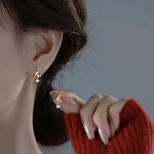 Christmas tree earrings with colorful crystals and zircon drop on model in red sweater