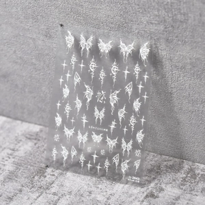 Detail of 5D white embossed butterfly and gothic cross nail stickers on transparent film