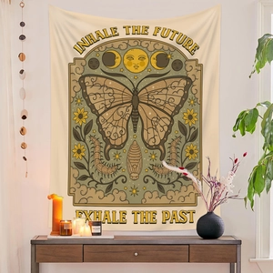 Detail of bohemian tapestry featuring butterfly and moon phase with inspirational quote