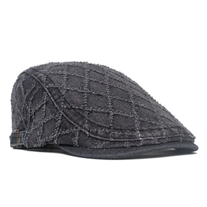 Detailed view of grey denim beret with diamond stitching and vintage frayed edges