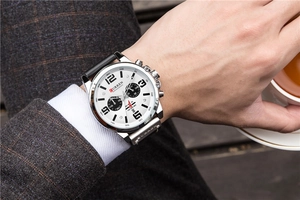 Close-up of men's quartz chronograph watch with silver case and black leather strap