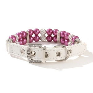 Detail view of double-layer purple pearls and rhinestone buckle on white pet collar