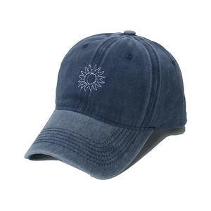 Washed navy denim baseball cap with sun and moon embroidery in a 3D side view