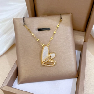 Double layered heart necklace with mother of pearl and cubic zirconia in a beige gift box