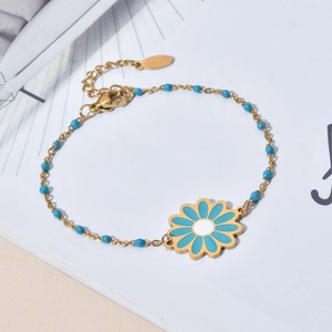 Gold stainless steel daisy pendant bracelet with blue beads in a minimalist setting