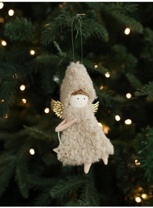 Detail of plush Christmas angel with gold wings and sequin star hanging on a tree