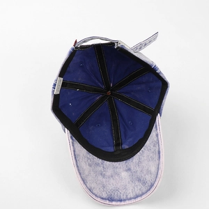 Inside view of washed blue cotton baseball cap showing black sweatband and metal buckle
