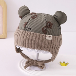 Detail of baby bear ear flap hat with lucky bear print and corduroy texture