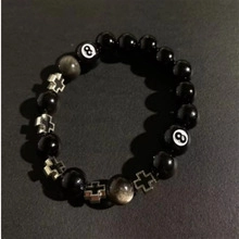 Detail von Perlenarmband mit schwarzen Perlen, Silberkreuz und Nummer 8 Billardkugel
