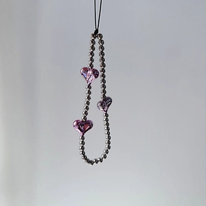 Detail of silver beaded phone strap featuring three purple 3D heart-shaped pendants