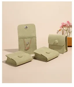 Macro detail of microfiber jewelry pouch with snap button and swan necklace storage