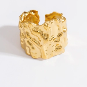 Macro detail of 18k gold plated stainless steel ring with organic lava texture
