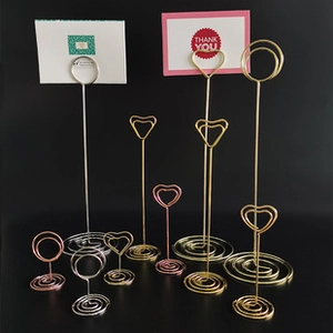 Macro detail of heart and round shaped metal wire photo holders in assorted heights