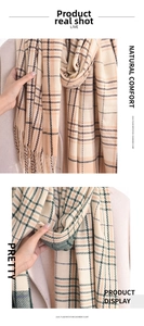 Close-up of imitation cashmere plaid scarf with soft tassels and striped border details