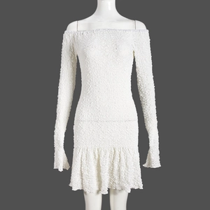 Close-up of white off-shoulder mini dress featuring 3D seersucker texture and ruffled hem
