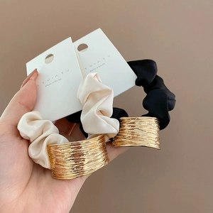 Minimalist beige and black fabric hair ties with geometric gold metal rings decoration