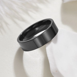 Minimalist black stainless steel ring with high-polished surface and smooth flat edge finish