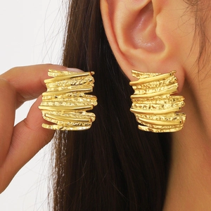 Chic 18k gold irregular textured stud earrings shown on model for elegant style