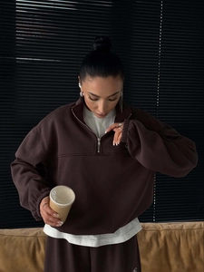 Detailed texture of chocolate brown half-zip sweatshirt with premium cotton fabric