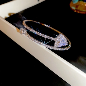 Macro shot of double-layered silver bangle with triangular zircon and pavé setting