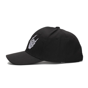 Black cotton baseball cap featuring white embroidery of skull palm in a street hip-hop style