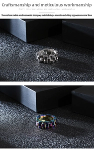 Close-up of industrial watch link style stainless steel rings in silver and rainbow colors
