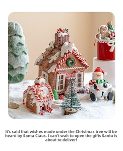 Miniature Christmas scene with resin gingerbread house, snowman and snowy pine trees