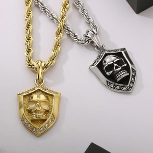 Punk style stainless steel shield pendants with skull relief and rhinestone accents