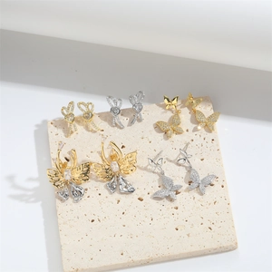 French vintage gold and silver butterfly earrings with white zircon on stone display