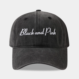 Macro detail of washed black cotton baseball cap with Black and Pink embroidery